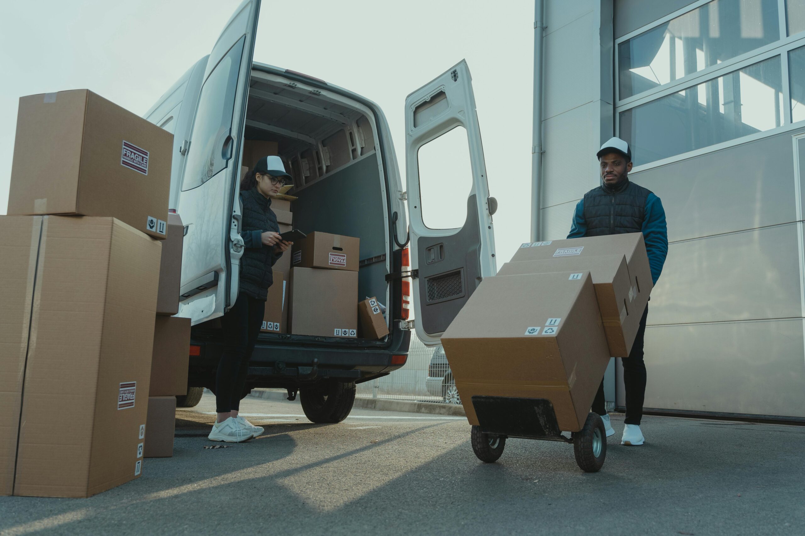A couple of guys transporting moving boxes